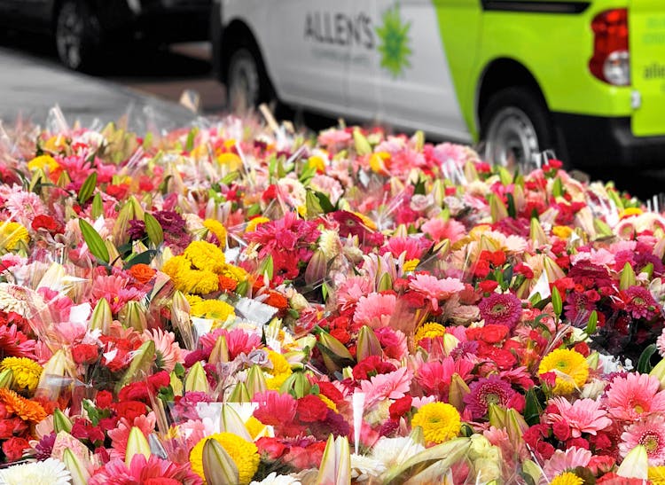 Dozens of bright, spring-themed bouquets awaiting delivery